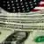 Dollar bills over American flag