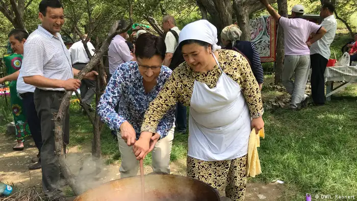 Lydia Rahnert (left), Country Manager of DW Akademie for Kyrgyzstan, attends the plov get-together. Cooking together is a way for journalists to get in touch with the people in the region. (DW/L. Rahnert)