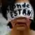 A woman covering her face in protest during a march for the missing Mexican students