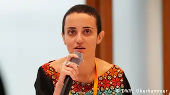 Lina Attalah speaks at a microphone
