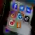 A smart phone screen displays social media platforms' application icons of Facebook, Instagram, Twitter, TikTok,