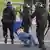 A protester in Minsk being detained by Belarusian police