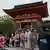 Tourists dressed in traditional Japanese outfits pose for photographs in front of the Kiyomizu Temple in Kyoto, Japan