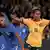 Mary Fowler in a Matildas jersey celebrating a goal with her arms outstrecthed.