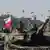 Polish soldiers on tanks take part in a military parade in Warsaw on Polish Army Day