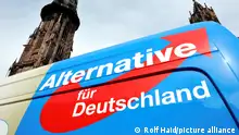 The AfD logo on a van next to a church in Freiburg 