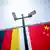 Chinese and German flags with security cameras above them